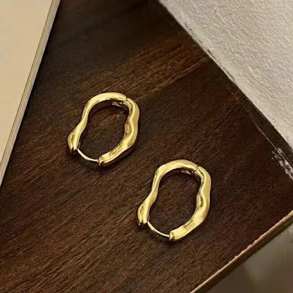 Aros geométricos de metal dorado y plateado: diseño moderno y minimalista.